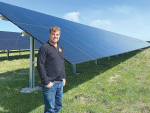 Robin Oakley with the solar panel installation now powering the packing shed at the company&#039;s Southbridge base. Photo supplied.