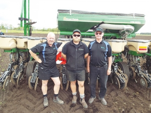 Waikato contractors Brent, Nick and Colin McFarlane beside their Great Plains maize planter.