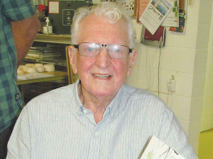 Author and former apple grower, Chris Smellie, signing copies of his book.