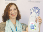Emily Thomas, Fonterra’s sustainable packaging lead, with a milk bottle made from Brazilian sugar cane.
