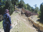 Kara Lynn at one of the smaller of the chasms which opened up on the property she farms with husband Steve Palmer, near the epicentre of the November 14 earthquake.
