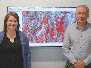 DoC scientific officer Terry Greene (right), and geospatial analyst Ann De Schutter with a false-colour image of the area near Pukaki.