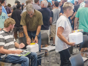 Dairy farmers collect their individualised milk sampling packs at the start of the first nationwide Mycoplasma bovis testing programme. This time farmers do not have to take samples themselves. 