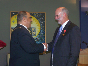 Colin Harvey receiving his Officer of the New Zealand Order of Merit insignia from then Governor General Sir Anand Satyanand in April 2008.