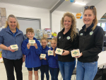 Fonterra area managers Alison Hall (second right) and Sam Flight (far right) dropping off donations of Duck River Butter to Bridport Primary School for their breakfast club.