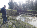 Chris Allen at a washout where a culvert burst in his Ashburton Forks farm during the big rain event at the end of May. Photo Credit: Nigel Malthus.