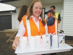 Jaymee Smith serves tea during the opening last week.