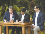 NZM CEO John Brakenridge, left, signs the partnership agreement with Actual co-founders Dr Karthik Balakrishnan and Dr Derek Lyons. Photo supplied by Actual.