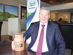 Former Fonterra chairman John Monaghan with his farewell gift from the Fonterra Shareholder's Council - a wooden cream can carved from a Totara post.