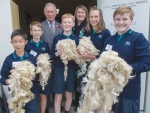Prince Charles, Campaign for Wool NZ chair Phillipa Wright and children from Tawa Intermediate discover the qualities of wool.
