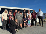 From Left to Right: Fiona Buchanan (Kaikōura District Council Regulatory Administration Officer), Joanna York (Kaikōura District Council Recovery Manager), Bonnie Taylor (baby), Zoe Howden (kneeling in front) with her son Dalton Howden, Ata Kahu, Horiszn Kahu and Shaden Kahu (two boys in grey uniform), Tessa Taylor (head out the window), Indie Taylor (standing below her), Weston Howden (standing in front of Indie), Bub Taylor (mum in striped t-shirt), Ria Taylor (in front of her mum). Scott McDermid (Blenheim Toyota CEO in the ABs shirt), Cory Rowden (Blenheim Toyota Branch Manager).