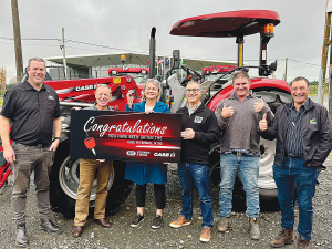 Lil Poulton with the family’s new Case IH tractor. Others in the picture, from left are Robby Smith, Murray Grant, Terry Copeland, John Kilmister and Jim Galloway.