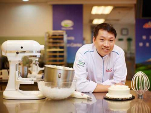 Anchor Food Professionals chief director China chef team Teoh Joo Cheong in the kitchen with UHT whipping cream.