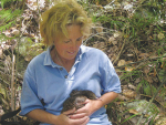 Northland farmer Jane Hutchings with a kiwi on her farm.