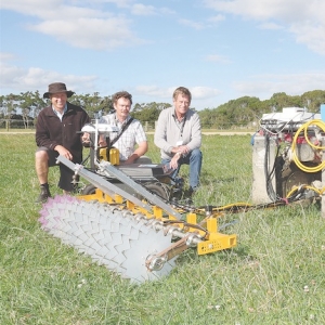 Bert Quin, Geoff Bates, and Peter Bishop show off their device.