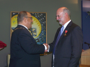 Colin Harvey receiving his Officer of the New Zealand Order of Merit Insignia from then Governor General Sir Anand Satyanand in April 2008.