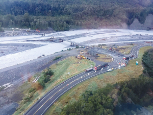 An aerial view of the work site where Downer and Army engineers are preparing the Bailey bridge replacement for the washed-out State Highway 6 bridge at Franz Josef. Supplied/DOWNER.