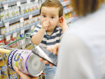 Willem, 14 months old, waits while mum Emma scans her can of Annum.