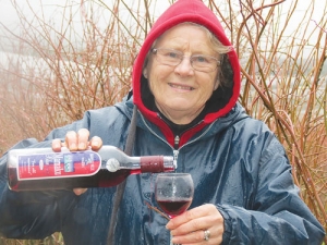 Anne Frost samples some blueberry wine.