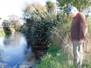 Farmer Bill Wilson admires the much improved Waikuku stream, one of two streams for which the Waikuku Water Management Group has won an Environmental Award from Fish &amp; Game.