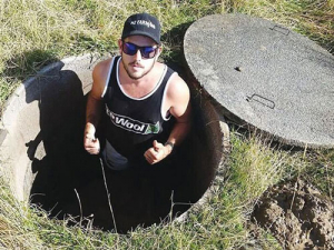 The founder of the NZ Farming Facebook page and instigator of its volunteer relief effort, Tyler Fifield, in a well on a farm near Kaikoura. The volunteers were trying to deepen the well by hand shovels after it dried up.