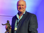 Lincoln University Professor Derrick Moot with the Ray Brougham Trophy.