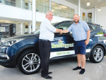 Greenlea livestock manager Bruce Mudgway (right) hands over a Santa Fe to WRST chair Neil Bateup.