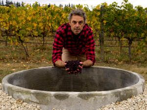 Dom Maxwell with the concrete fermenter Greystone has been using for the past three years. Photo by Richard Brimer.