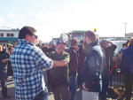 Farmers and tradies gather in Morrinsville before they took to the streets in their tractors and utes.