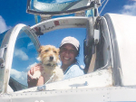 Aerospread pilot Jess McNeil and canine friend get set for another mission to help out struggling farmers in Tolaga Bay.