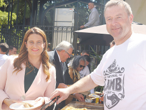Associate Agriculture Minister Mark Patterson serves NZ lamb to Finance Minister Nicola Willis at a barbeque in Parliament grounds recently.