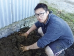 Lawrence Jiang kneading cow dung for a biodynamic preparation at Wright’s Vineyard and Winery. 