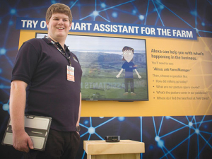 Massey master’s student Hayden Wilson with Massey’s artificially intelligent farm assistant.