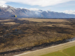 Helicopters with monsoon buckets attack the big Lake Ohau fire. Photo: Ned Dawson/FENZ.