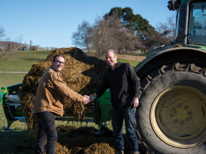 Nigel Holt (left), Hustler territory manager, and David Acland shake hands at the handover of the bale feeder prior to its maiden run on the Mid Canterbury-based farm.