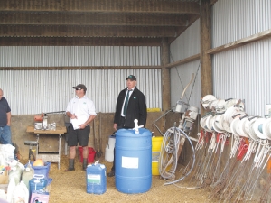 Auctioneer Pat Sheely (right) talks potential buyers into a sale at the farm.