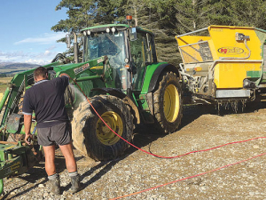 Washing down machinery on Ben Walling and Sarah Flintoft’s M. bovis-infected farm at Lumsden. SUPPLIED