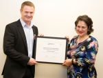 Dahook Azzam, 2015 Poultry Trainee of the Year (right), receives her award from PIANZ Chairman, Adrian Revell.