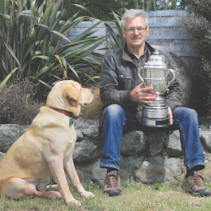 Clive’s Labrador is suitably impressed with the trophy.