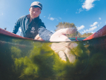 NIWA water quality technician Curtis Picken at the Piakoiti Stream where a trial is underway growing algae to remove agricultural runoff. Photo Credit: Stuart Mackay, NIWA