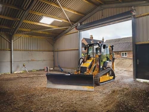 A JCB ICX-T levelling a barn.