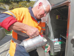 Tanker driver Justin Wells collects milk samples for testing during his milk run.