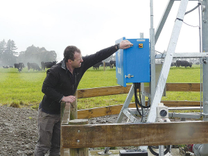 Farm manager Bryan Mitchell checks the control panel of a new pivot.