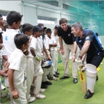 Stephen Fleming and Nathan Guy coach cricket for Sri Lankan children.