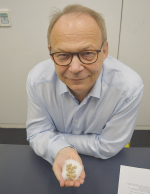 DSM chief executive Christoph Goppelsroeder with a handful of 3-NOP pellets.