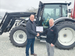 Tama president Kyle Baxter congratulates Paul Wilkins on his long career in the farm machinery game.