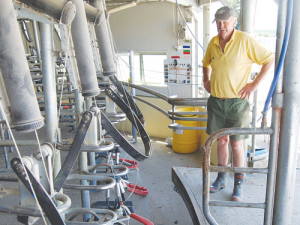 Don Galletly shows the damage to his rotary shed.