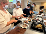 Alliance Group 2023 Graduates from left to right Chloe Lennox, Abigail Stewart, William Hii, and Travis McKenzie serve meals for guests of Ronald McDonald House in Christchurch.