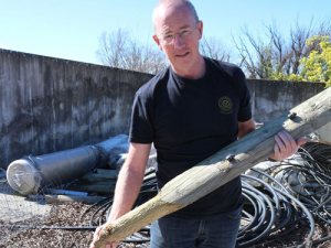 Bruce Forlong with a broken post that has been machined to fit within the steel sleeve.