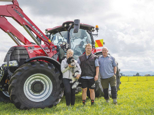 Sam Cane (centre) is pictured with his deer farming parents Kathy and Malcolm in front of their Case Puma 165.
